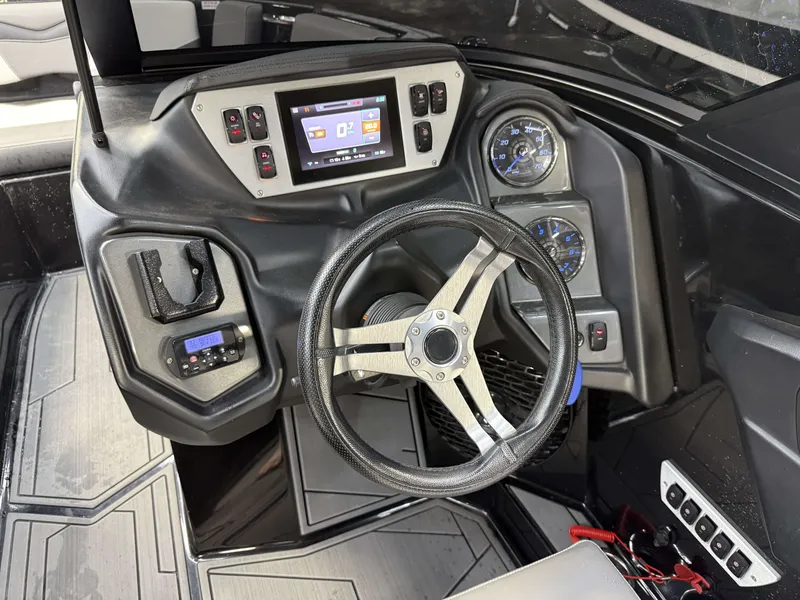 Slide: The Image of The image shows the cockpit of a 2020 Supreme ZS 232 boat with a modern helm. - 19