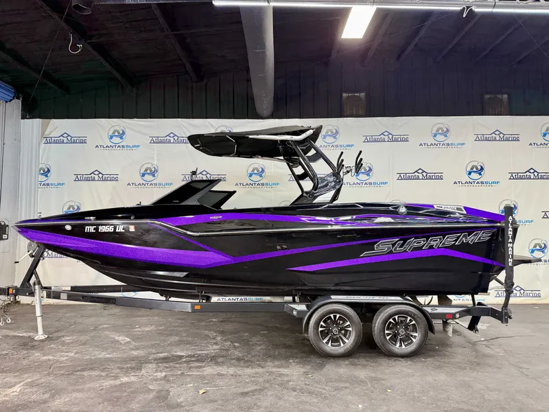 Slide: The Image of A 2020 Supreme ZS 232 boat on a trailer in a showroom. - 2