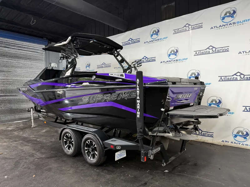 Slide: The Image of A 2020 Supreme ZS 232 boat on a trailer in a showroom. - 28
