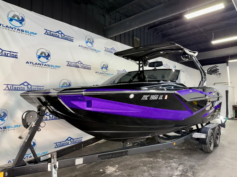 Slide: The Image of A black and purple boat, Supreme ZS 232 model, sits on a trailer in a showroom. - 3