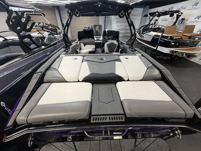 Slide: The Image of The image shows the rear of a 2020 Supreme ZS 232 boat with cushioned seating. - 6