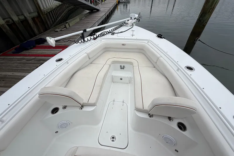 Slide: The Image of 2020 Sea Hunt Ultra 275 SE boat interior with white seating and fishing rod holders. - 12