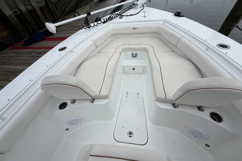 Slide: The Image of 2020 Sea Hunt Ultra 275 SE boat interior with white cushioned seating and deck details. - 13