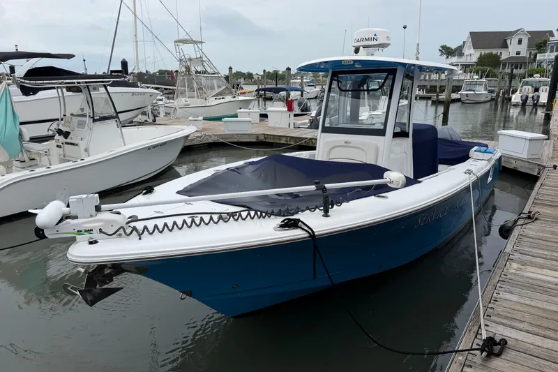 Slide: The Image of 2020 Sea Hunt Ultra 275 SE boat docked at marina, featuring blue hull and Garmin equipment. - 6