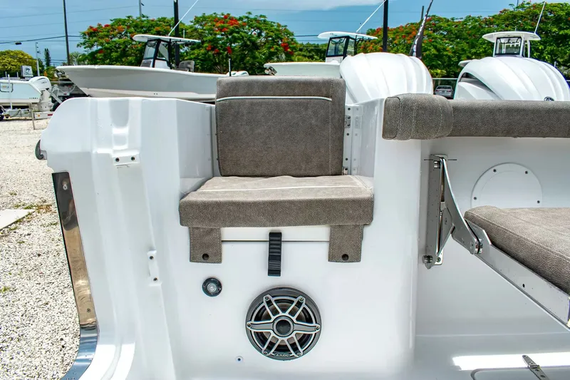 Slide: The Image of Rear view of a Sea Hunt Gamefish 25 with gray cushions and a speaker. - 10