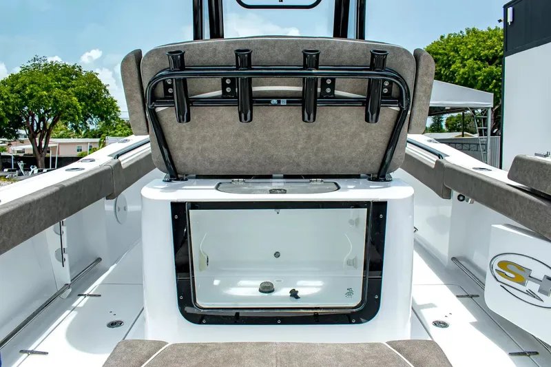 Slide: The Image of The image shows the cockpit of a Sea Hunt Gamefish 25 boat with fishing rod holders. - 11