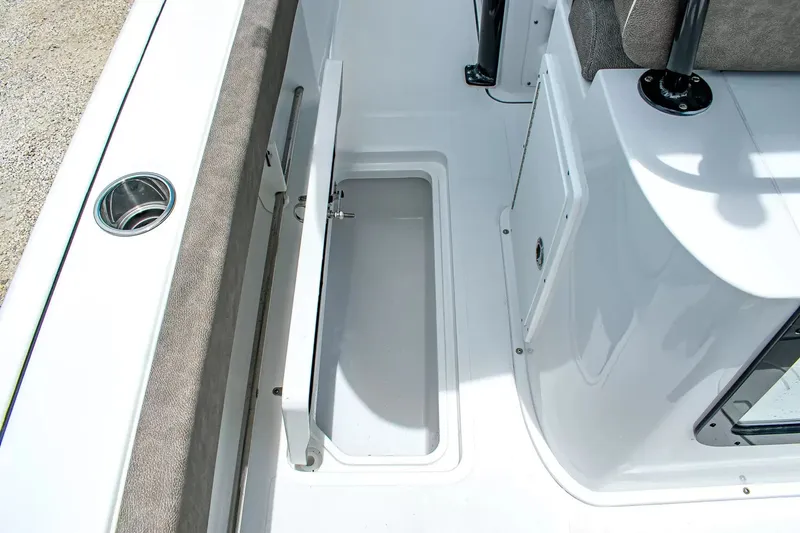 Slide: The Image of An open storage compartment on a boat with white and gray surfaces. - 12