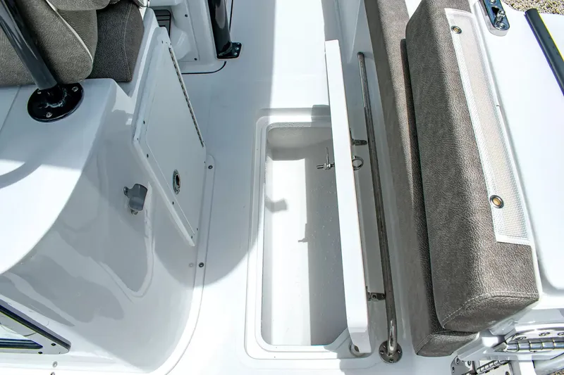 Slide: The Image of An open storage compartment on a boat with gray upholstery and white surfaces. - 13