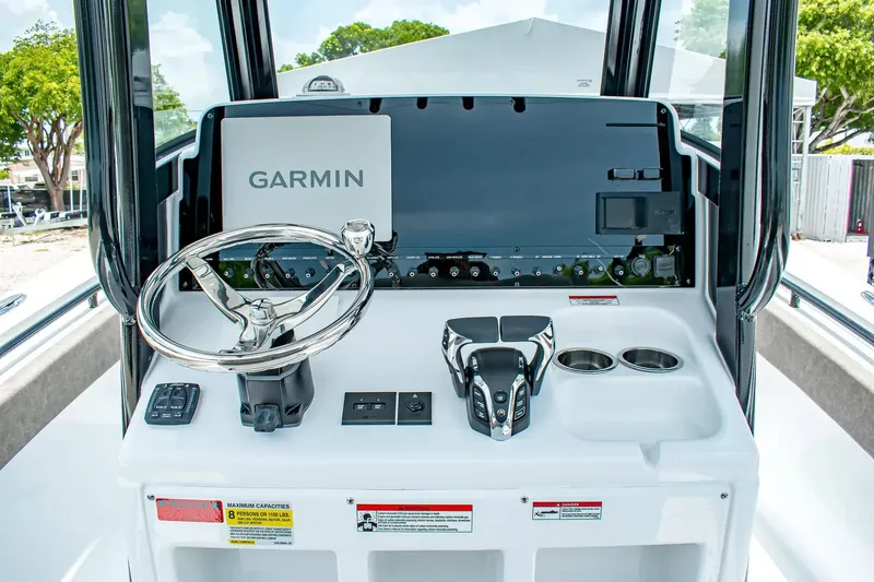 Slide: The Image of The image shows the helm of a Sea Hunt Gamefish 25 boat with a Garmin display. - 16