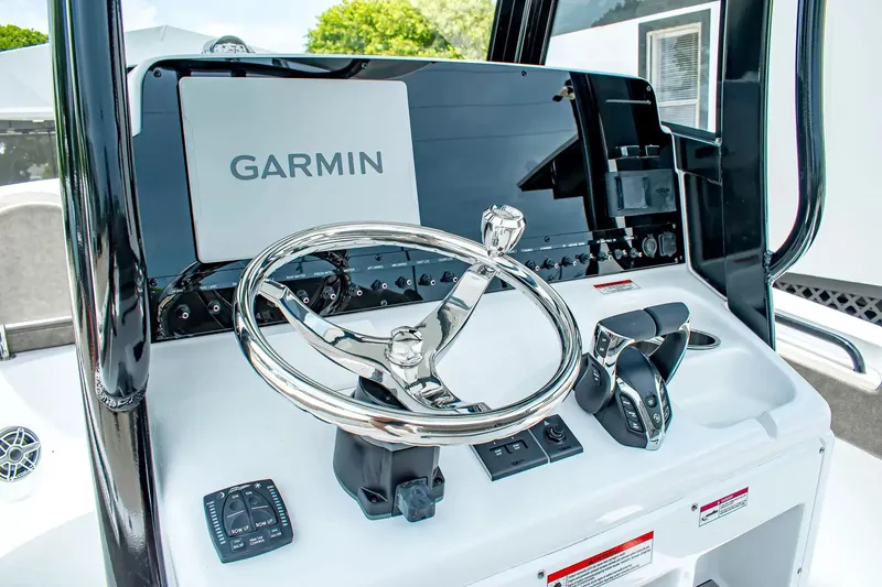 Slide: The Image of The image shows the helm of a Sea Hunt Gamefish 25 boat with a Garmin display. - 17