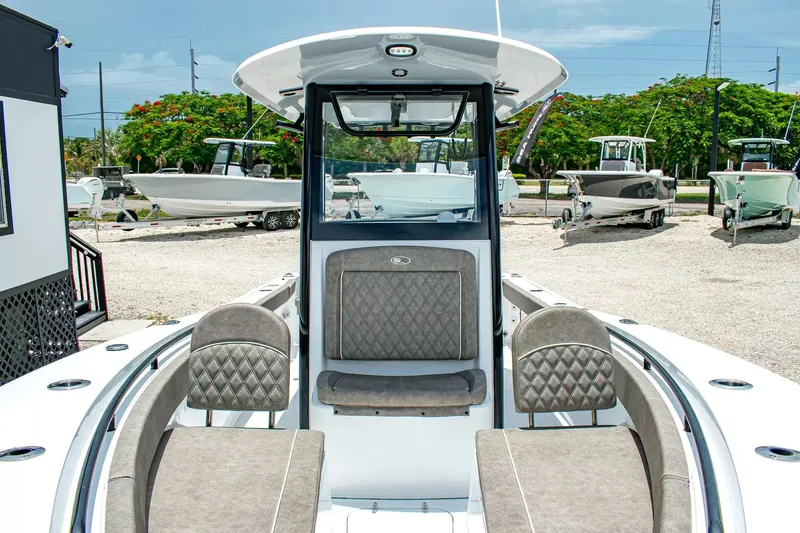 Slide: The Image of The image shows the cockpit of a Sea Hunt Gamefish 25 boat with gray upholstery. - 22