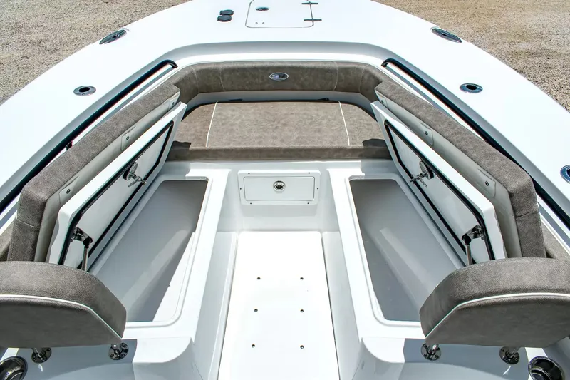 Slide: The Image of The image shows the bow of a Sea Hunt Gamefish 25 boat with open storage compartments. - 24