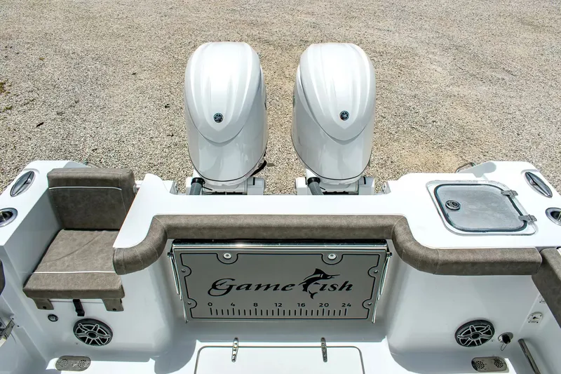 Slide: The Image of Two outboard engines on a boat with gray upholstery and a fish box. - 4