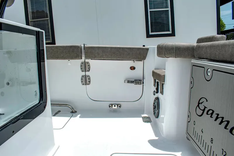 Slide: The Image of The image shows the cockpit of a Sea Hunt Gamefish 25 boat with cushioned seating. - 6