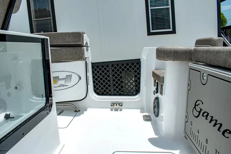 Slide: The Image of The image shows the cockpit of a Sea Hunt Gamefish 25 boat with cushioned seating. - 7