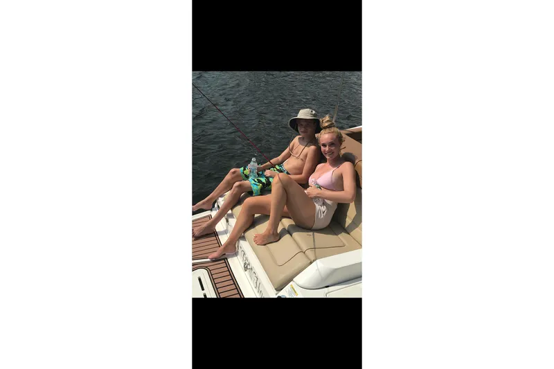 Slide: The Image of Two people relaxing on a 2014 Sea Ray 260 Sundeck boat. - 10