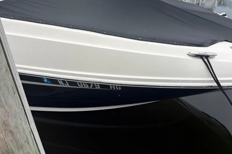 Slide: The Image of 2014 Sea Ray 260 Sundeck boat docked with cover, registration NJ 0679 HG. - 13