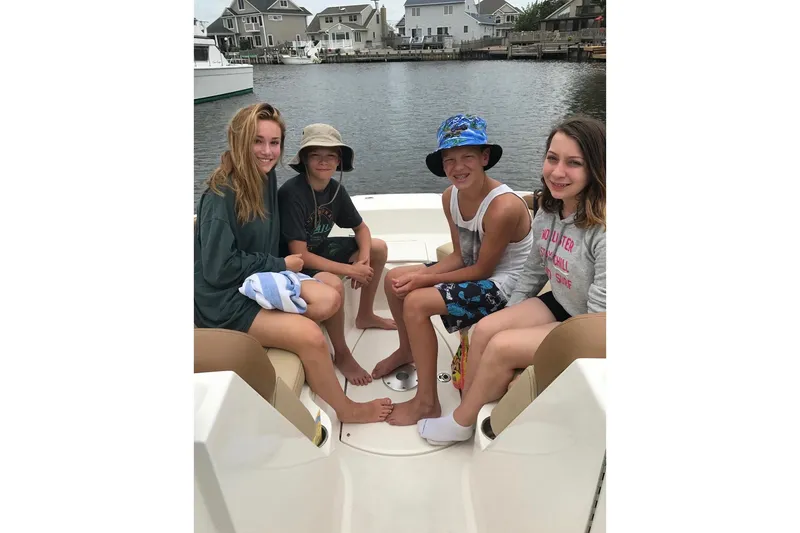 Slide: The Image of Group of kids enjoying a day on a 2014 Sea Ray 260 Sundeck boat. - 15