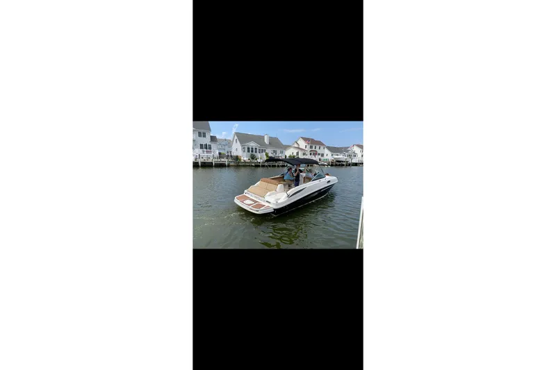 Slide: The Image of 2014 Sea Ray 260 Sundeck boat cruising near waterfront homes. - 4