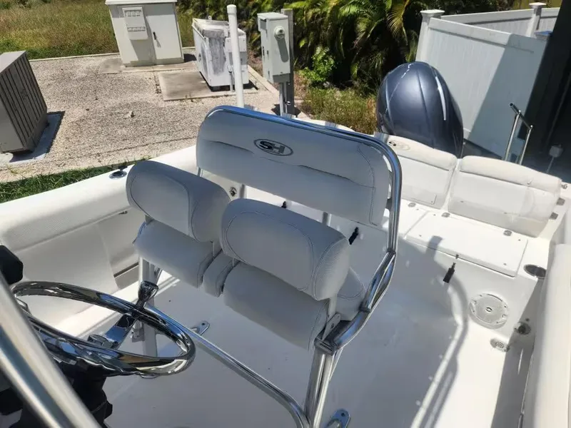 Slide: The Image of The image shows the cockpit of a 2017 Sea Hunt Ultra 255 SE boat with white seating. - 6