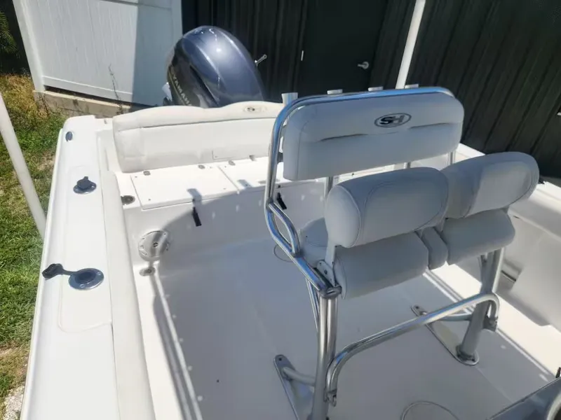 Slide: The Image of The image shows the cockpit of a 2017 Sea Hunt Ultra 255 SE boat with two padded seats. - 7