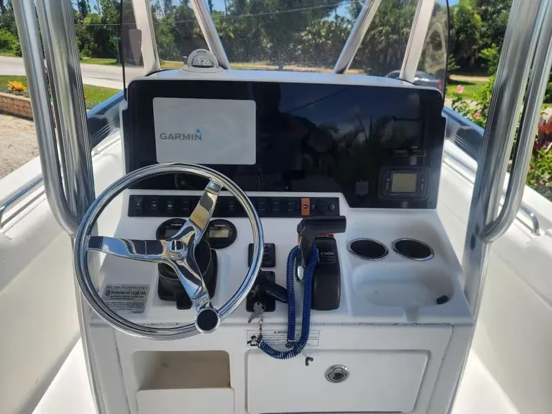 Slide: The Image of The image shows the helm of a 2017 Sea Hunt Ultra 255 SE boat with Garmin navigation. - 8