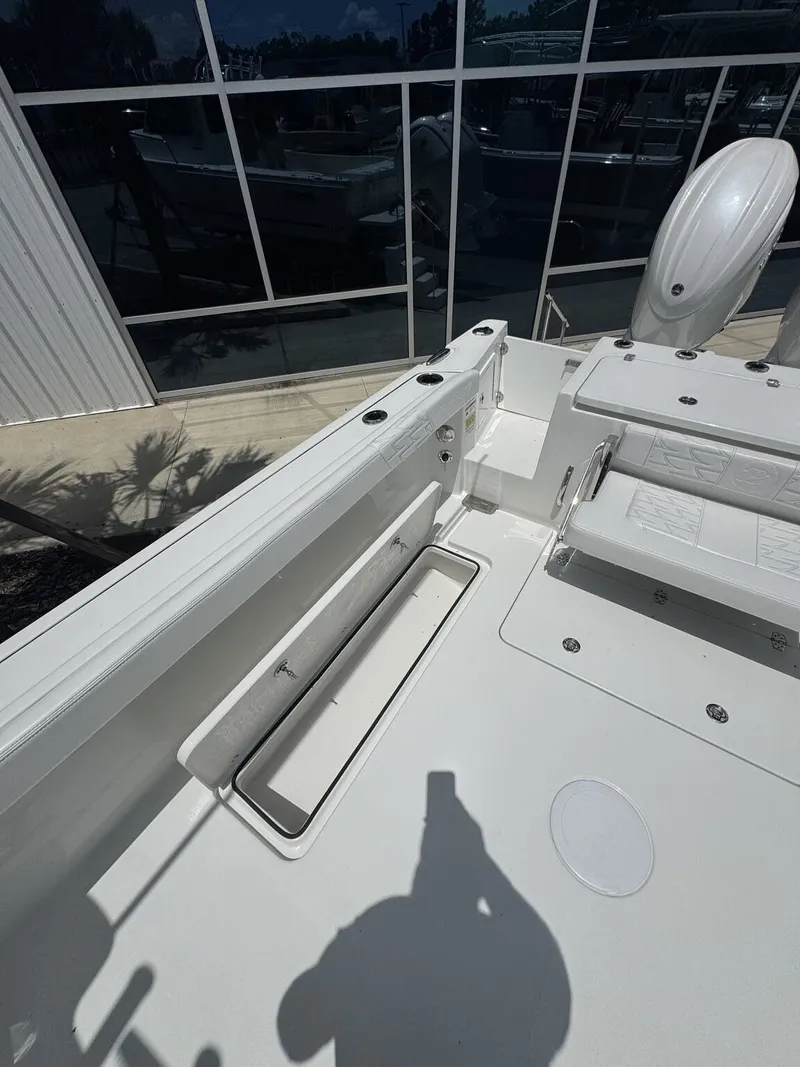 Slide: The Image of The image shows the deck of a Parker 247 Explorer boat with seating and storage. - 10