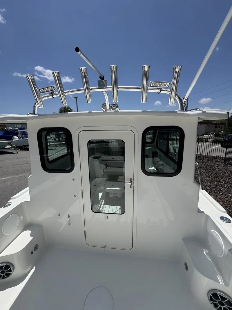 Slide: The Image of The image shows the stern of a Parker 247 Explorer boat with a door to the cabin. - 11