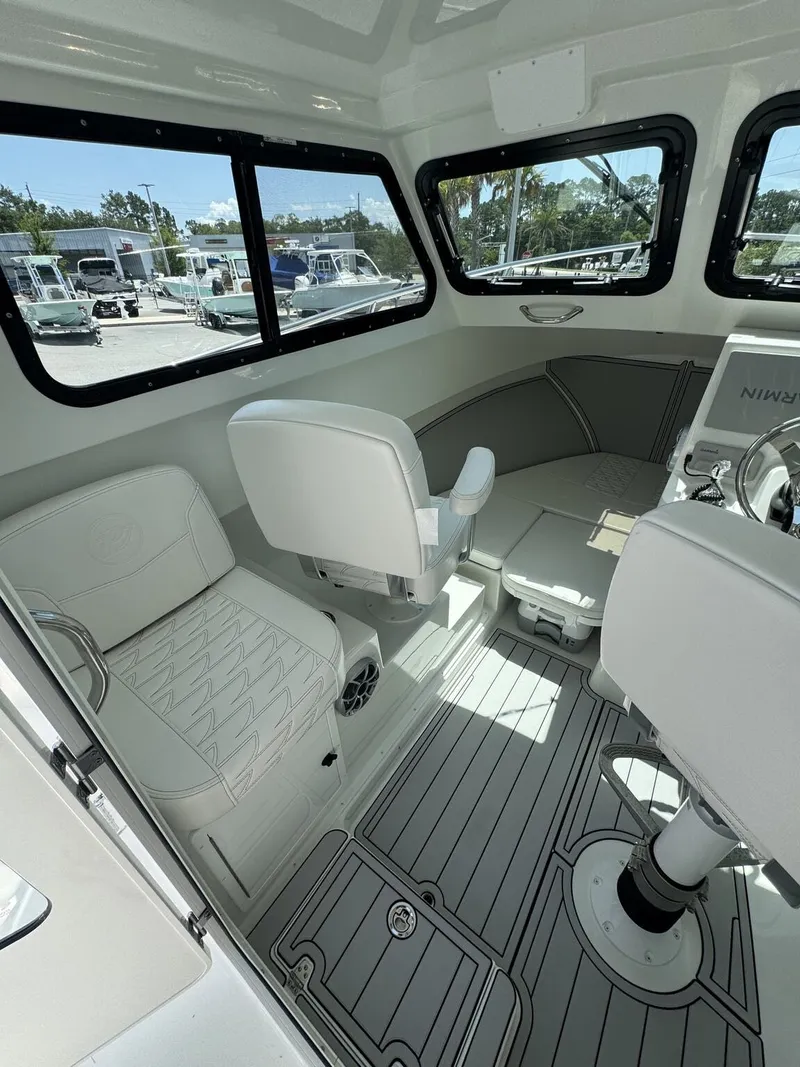 Slide: The Image of Interior of a 2027 Parker 247 Explorer with white seating and gray flooring. - 12