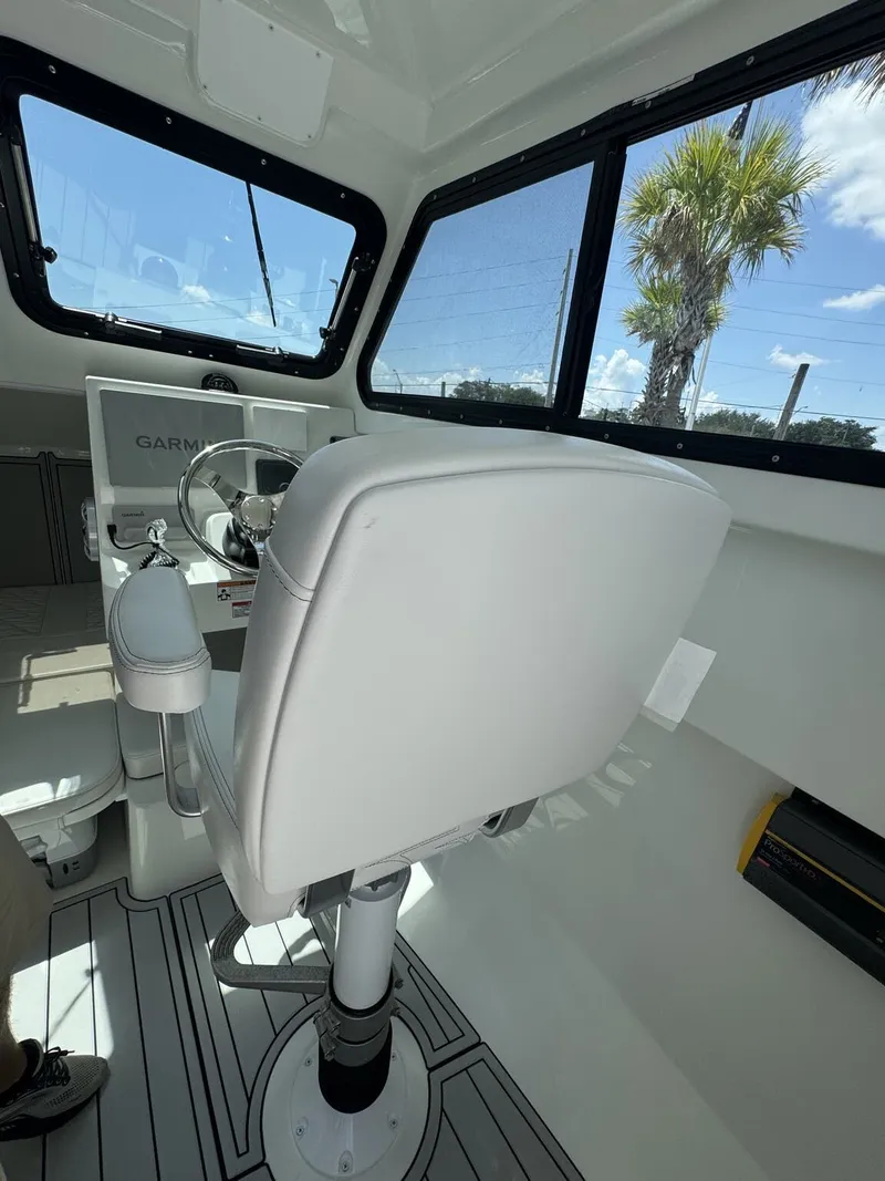 Slide: The Image of Interior of a 2027 Parker 247 Explorer with white seat and helm console. - 13