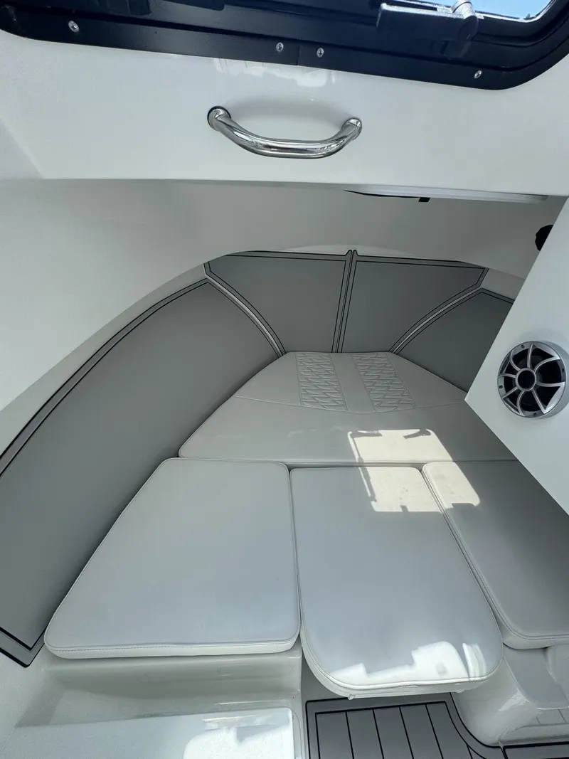 Slide: The Image of Interior of the Parker 247 Explorer with white cushions and a speaker. - 16