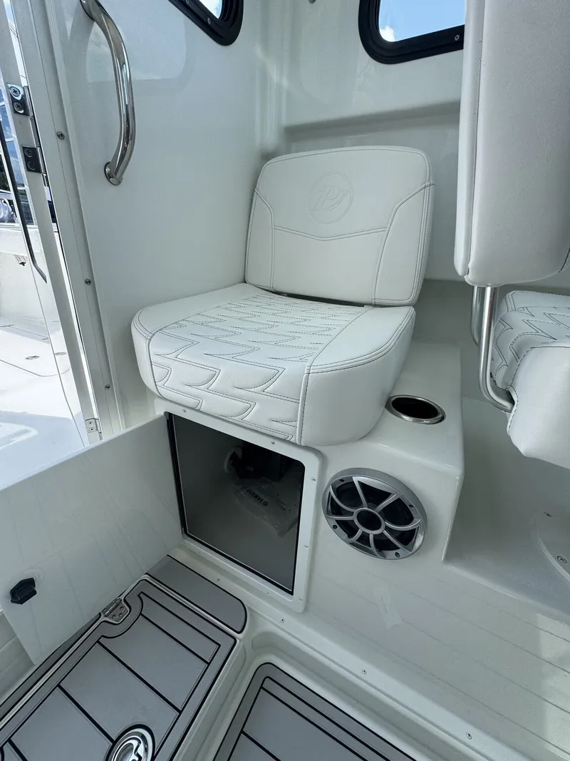 Slide: The Image of Interior of a Parker 247 Explorer with a white seat and speaker. - 17