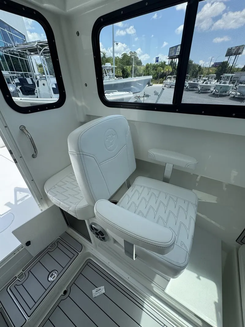 Slide: The Image of Interior of a 2027 Parker 247 Explorer with white seating and windows. - 18