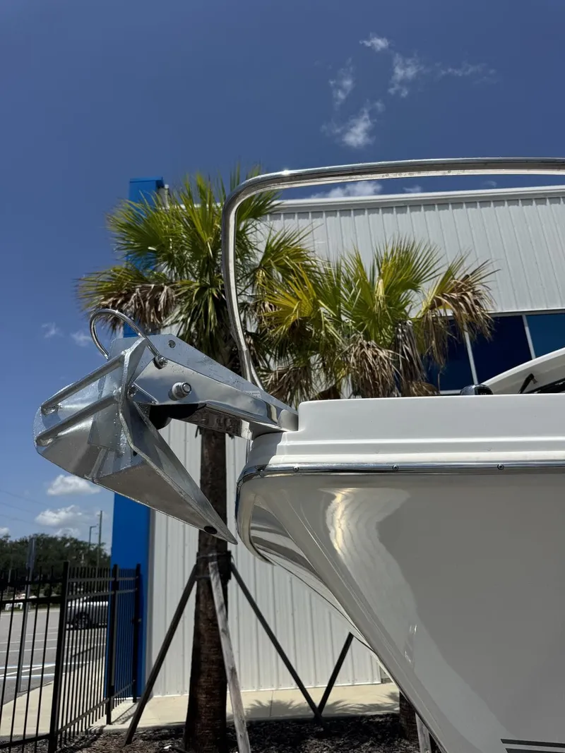 Slide: The Image of A 2027 Parker 247 Explorer with an anchor, in front of a building with palm trees. - 2