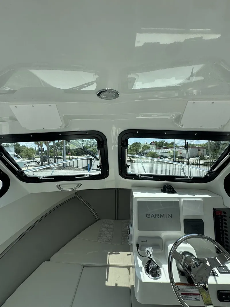 Slide: The Image of Interior view of a 2027 Parker 247 Explorer with helm and seating area. - 20