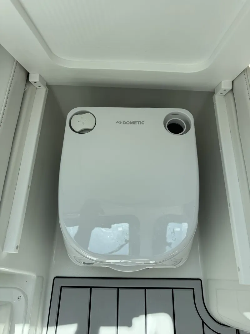 Slide: The Image of The image shows a Dometic toilet inside a boat. - 22