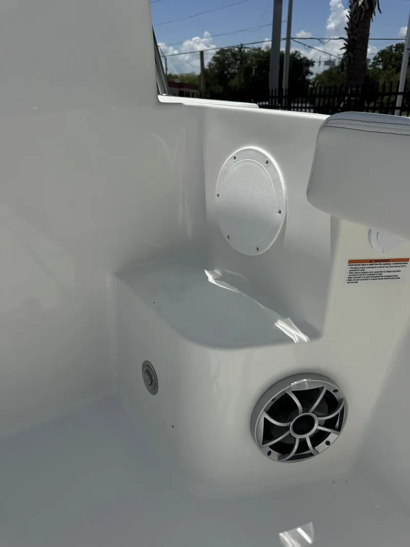 Slide: The Image of Close-up of a white boat interior with a speaker and seating area. - 23