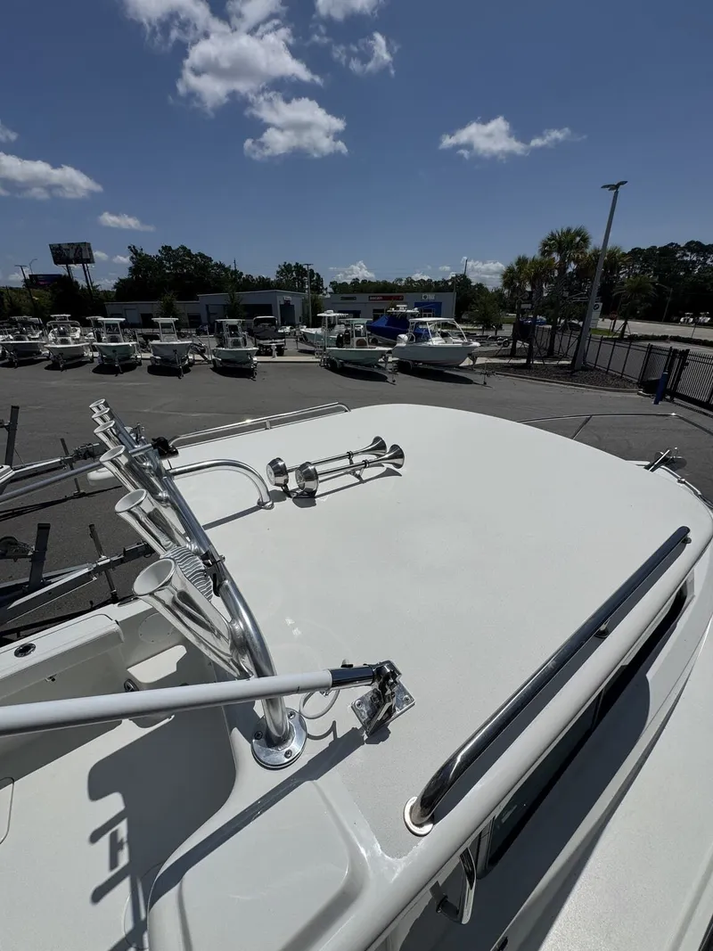 Slide: The Image of The image shows the deck of a 2027 Parker 247 Explorer, parked in a lot. - 24