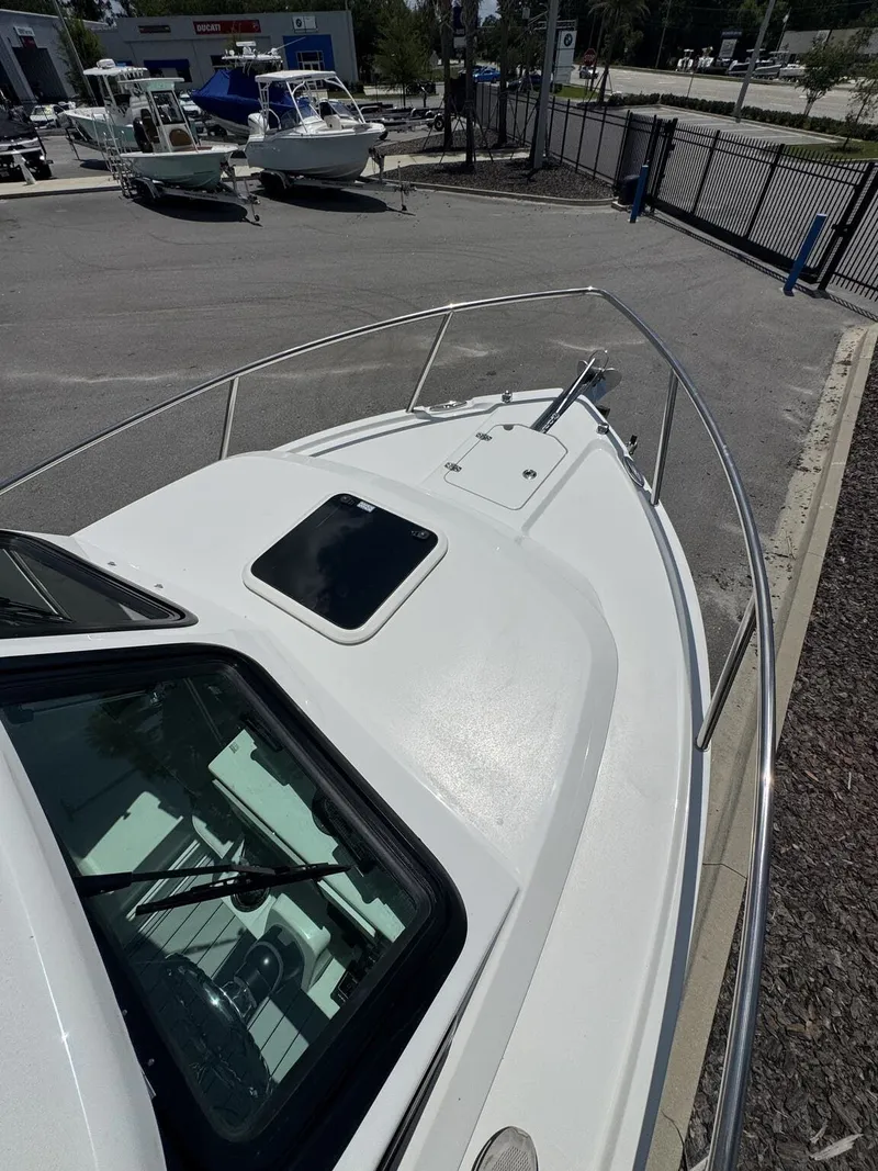 Slide: The Image of Foredeck of a Parker 247 Explorer with railing and hatch, parked on a lot. - 25
