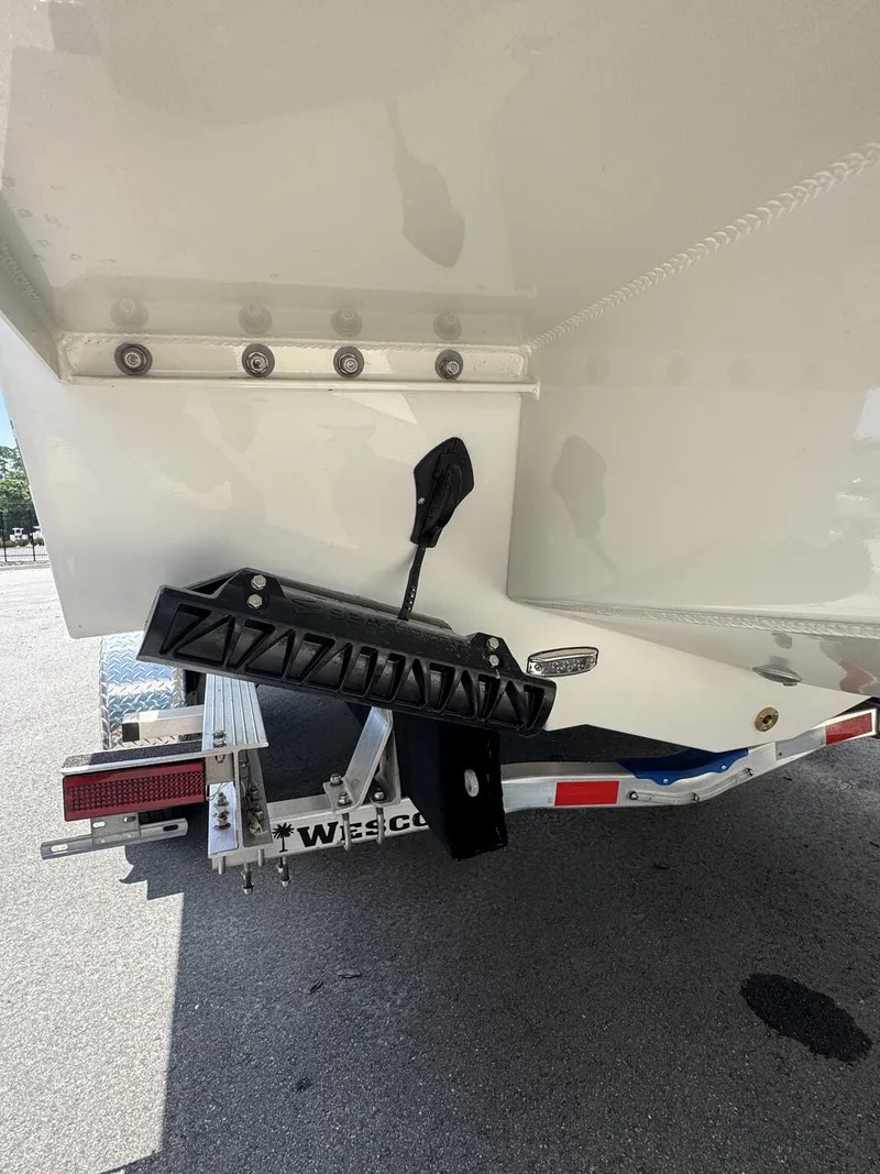 Slide: The Image of The image shows the stern of a Parker 247 Explorer boat on a trailer. - 4