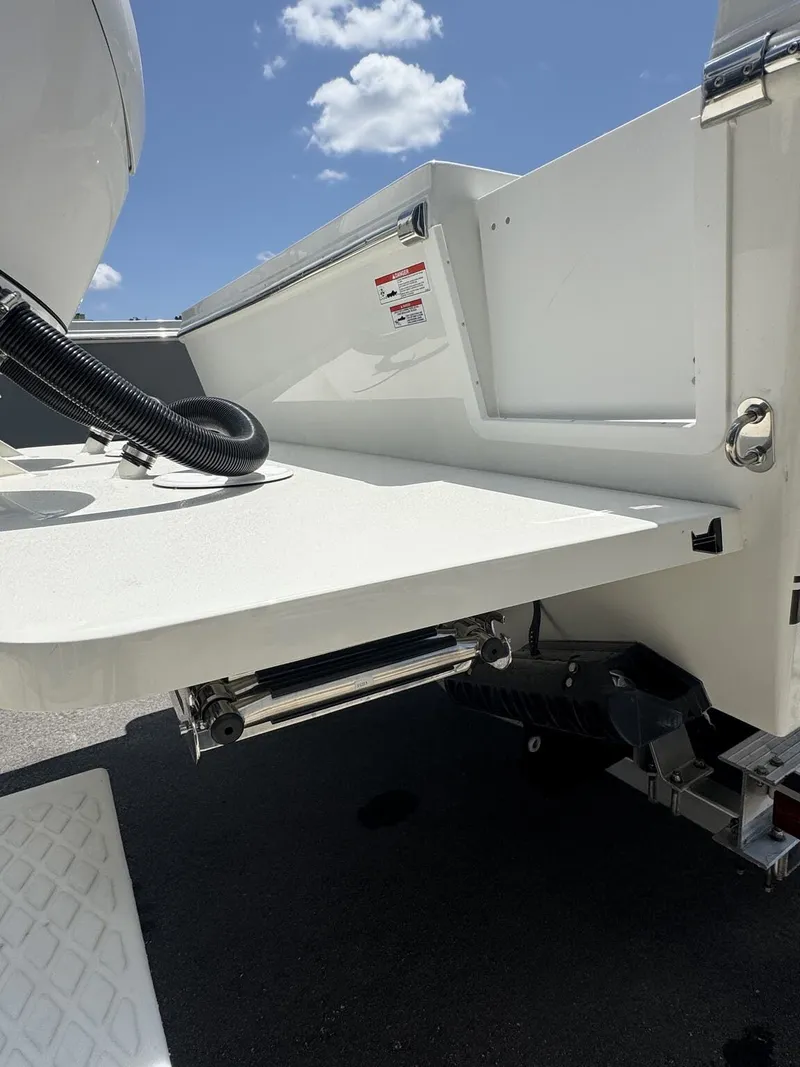 Slide: The Image of The image shows the stern of a Parker 247 Explorer boat with a platform and motor. - 6