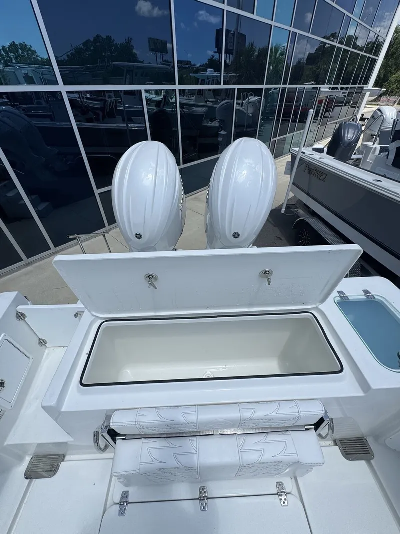 Slide: The Image of The image shows the stern of a Parker 247 Explorer with two outboard engines and a large storage area. - 8