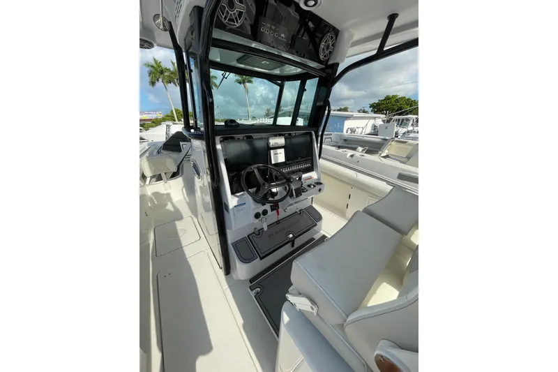 Slide: The Image of 2024 World Cat 325 CC boat cockpit with modern steering and navigation system. - 2
