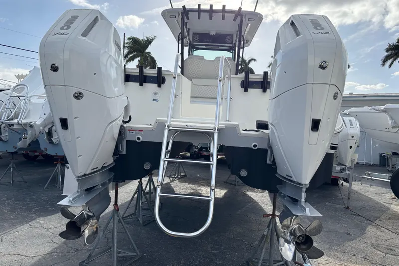 Slide: The Image of 2024 World Cat 325 CC boat with dual outboard engines, ladder, and sleek design. - 7