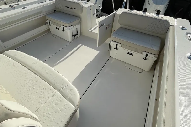 Slide: The Image of The image shows the cockpit of a World Cat 325 CC boat with white seating and storage. - 8