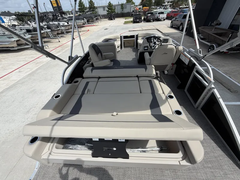 Slide: The Image of The image shows the interior of a 2024 Barletta A20UC pontoon boat with beige seating. - 30