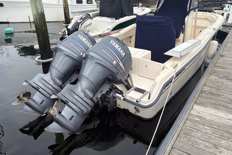 Slide: The Image of 2006 Grady-White Advance 257 boat with twin Yamaha outboard motors docked at marina. - 11