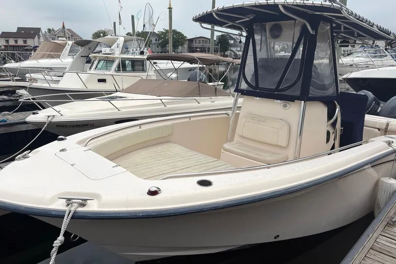 Slide: The Image of 2006 Grady-White Advance 257 boat docked at a marina, featuring a center console. - 2