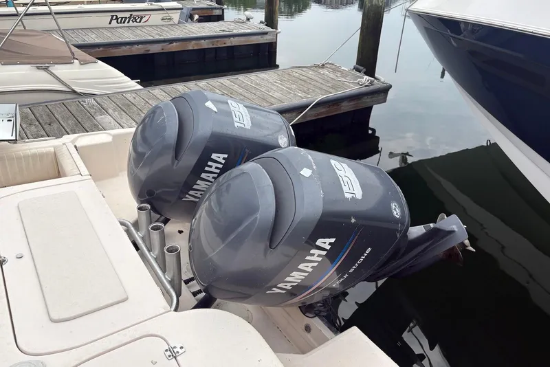 Slide: The Image of Twin Yamaha outboard engines on a 2006 Grady-White Advance 257 boat at dock. - 12