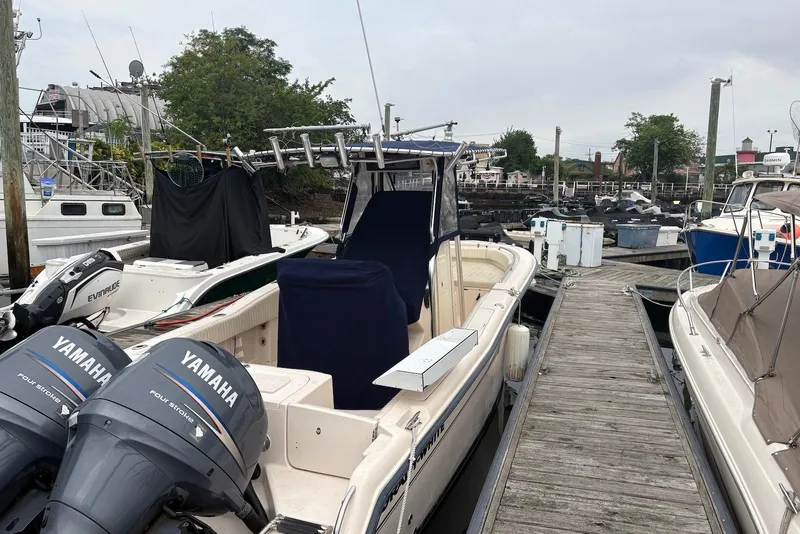 Slide: The Image of 2006 Grady-White Advance 257 boat docked with Yamaha engines, marina background. - 10